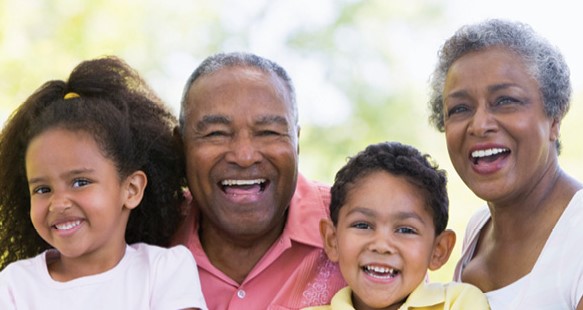 black family, grandparents and grandchildren smiling for photo